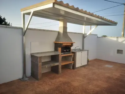 a kitchen with an outdoor oven with a roof at Casita Rural CONIL in Conil de la Frontera