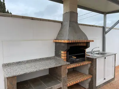 an outdoor kitchen with an oven and a sink at Casita Rural CONIL in Conil de la Frontera
