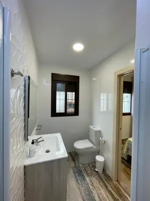 a white bathroom with a sink and a toilet at Casita Rural CONIL in Conil de la Frontera