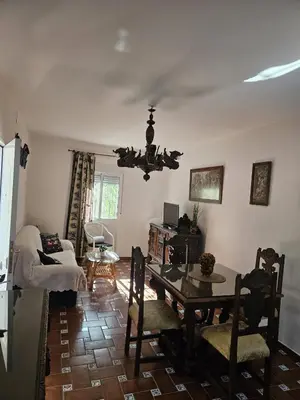 a living room with a table and a dining room at El Arrabal de la Barrosa in Chiclana de la Frontera