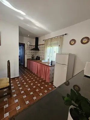 a kitchen with a refrigerator and a counter top at El Arrabal de la Barrosa in Chiclana de la Frontera