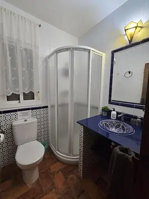 a bathroom with a shower and a toilet in it at El Arrabal de la Barrosa in Chiclana de la Frontera