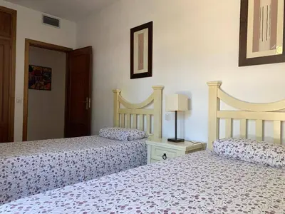 two beds sitting next to each other in a bedroom at Apartamento Galeón - Ole Solutions in El Puerto de Santa María