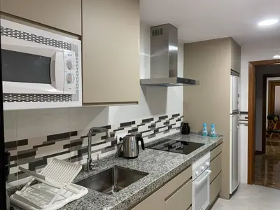 a kitchen with a sink and a microwave at Apartamento Galeón - Ole Solutions in El Puerto de Santa María