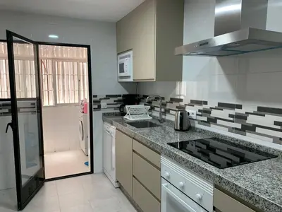 a kitchen with a sink and a counter top at Apartamento Galeón - Ole Solutions in El Puerto de Santa María