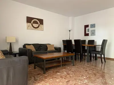 a living room with a couch and tables and chairs at Apartamento Galeón - Ole Solutions in El Puerto de Santa María