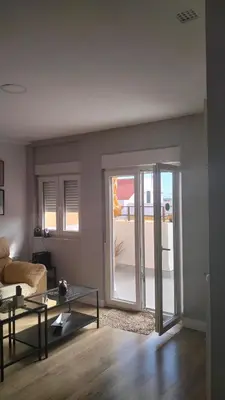 a living room with a couch and a table at Atico con terraza en San Fernando (Cádiz) in San Fernando