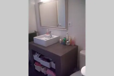 a bathroom with a sink and a toilet and a mirror at Atico con terraza en San Fernando (Cádiz) in San Fernando