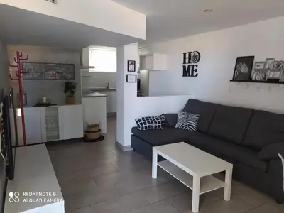a living room with a couch and a table at Apartamento en primera línea de playa in Sanlúcar de Barrameda