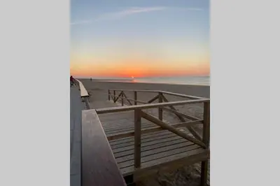 a view of the beach at sunset at Apartamento en primera línea de playa in Sanlúcar de Barrameda