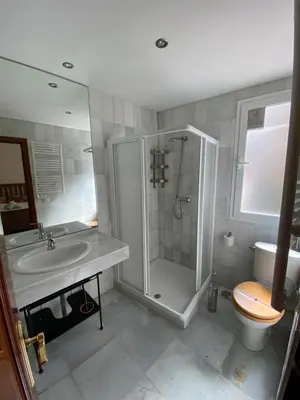 a bathroom with a shower and a sink and a toilet at MAGNÍFICO ÁTICO PLENO CENTRO. Terraza 60m. Climatizado, Garaje in Sanlúcar de Barrameda