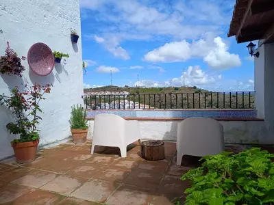 two white chairs sitting on a patio with a view at Casa Jaruf CENTRO HISTÓRICO Parking Gratuito Patio petfriendly in Arcos de la Frontera