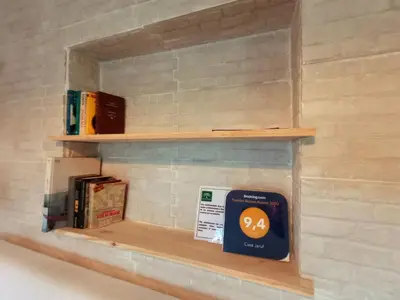 a shelf with a sign on a brick wall at Casa Jaruf CENTRO HISTÓRICO Parking Gratuito Patio petfriendly in Arcos de la Frontera