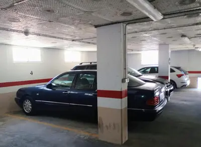 a parking garage with two cars parked in it at Casa Jaruf CENTRO HISTÓRICO Parking Gratuito Patio petfriendly in Arcos de la Frontera