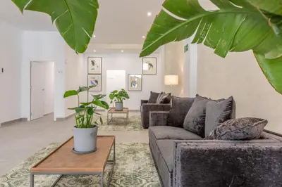 a living room with a couch and a table at Villamarta Boutique Rooms in Jerez de la Frontera