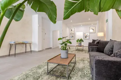 a living room with a couch and a table at Villamarta Boutique Rooms in Jerez de la Frontera