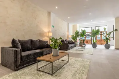 a living room with a couch and a table at Villamarta Boutique Rooms in Jerez de la Frontera