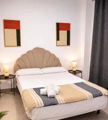 a bedroom with a bed with two towels on it at Villamarta Boutique Rooms in Jerez de la Frontera