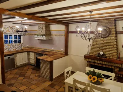 a dining room with a table and a chandelier at VACACIONES DE LUJO.CHALET PISCINA Y PLAYA.EL PUERTO in El Puerto de Santa María