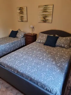 two beds sitting next to each other in a bedroom at VACACIONES DE LUJO.CHALET PISCINA Y PLAYA.EL PUERTO in El Puerto de Santa María