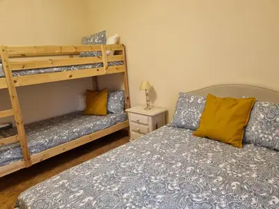 a bedroom with two beds and a bunk bed at VACACIONES DE LUJO.CHALET PISCINA Y PLAYA.EL PUERTO in El Puerto de Santa María