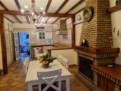 a dining room with a table and a fireplace at VACACIONES DE LUJO.CHALET PISCINA Y PLAYA.EL PUERTO in El Puerto de Santa María