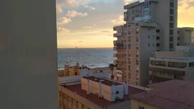 a view of the ocean from a building at Playa Victoria Ha Apartment in Cádiz