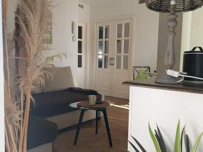 a living room with a couch and a table at ÁTICO VICTORIA BEACH in Cádiz