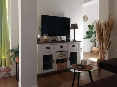 a living room with a television on top of a fireplace at ÁTICO VICTORIA BEACH in Cádiz