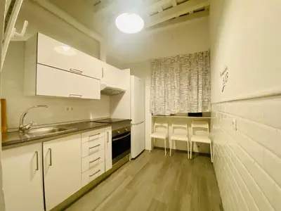 a kitchen with white cabinets and a sink and counters at La Posada de Sacramento Grupo AC Gestion in Cádiz