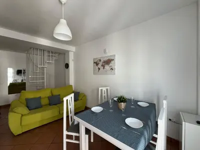 a living room with a table and a yellow couch at El Sardinero in Chipiona