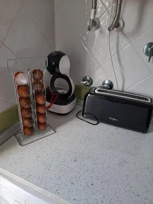 a kitchen counter with a toaster and a toaster and a dozen donuts at El Sardinero in Chipiona