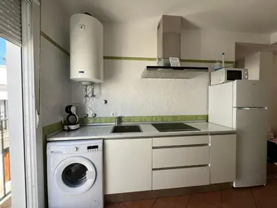 a kitchen with a washing machine and a washer at El Sardinero in Chipiona