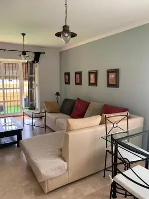 a living room with a couch and a table at Chiclana casa maría in Chiclana de la Frontera