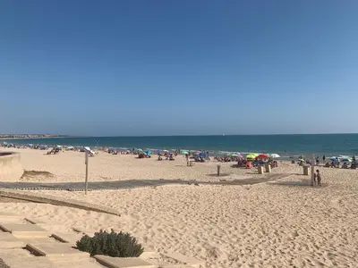 a group of people on a beach with the ocean at Chiclana casa maría in Chiclana de la Frontera