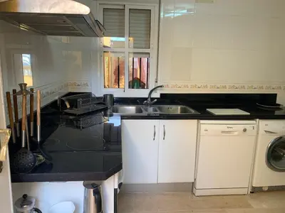a kitchen with a sink and a counter top at Chiclana casa maría in Chiclana de la Frontera