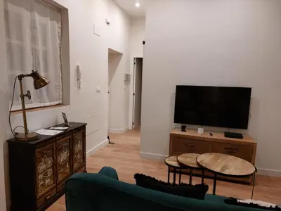 a living room with a tv and a couch at Hidden Gem Pasquin Suites in Mercado Central in Cádiz