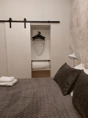a bedroom with a large bed and a closet at Hidden Gem Pasquin Suites in Mercado Central in Cádiz