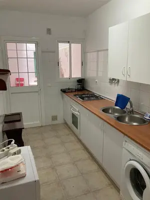 a kitchen with a sink and a counter top at Bajo con encanto a pie de playa in Chipiona