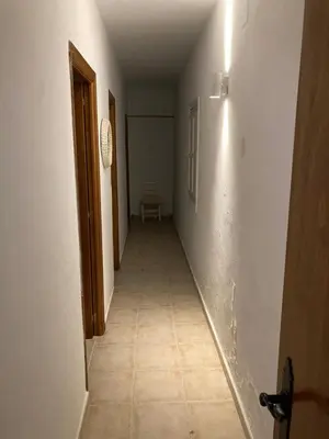 a hallway of a room with a tile floor at Bajo con encanto a pie de playa in Chipiona