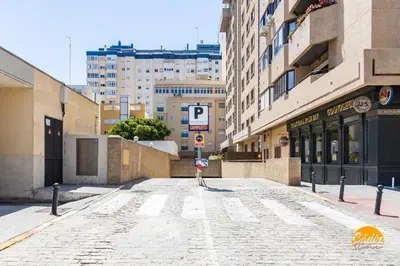 an empty street with a parking sign in a city at Loft Victoria Beach - FREE PARKING by Cadiz Time in Cádiz