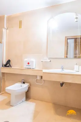 a bathroom with a sink and a toilet and a mirror at Loft Victoria Beach - FREE PARKING by Cadiz Time in Cádiz