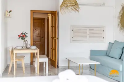 a living room with a blue couch and a table at Loft Victoria Beach - FREE PARKING by Cadiz Time in Cádiz