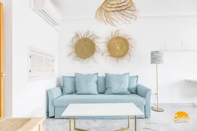 a living room with a blue couch and a table at Loft Victoria Beach - FREE PARKING by Cadiz Time in Cádiz