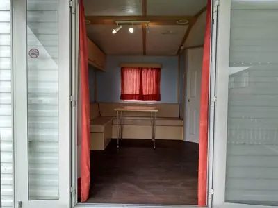 a door leading into a room with a red curtain at Residencial Robles in Sanlúcar de Barrameda