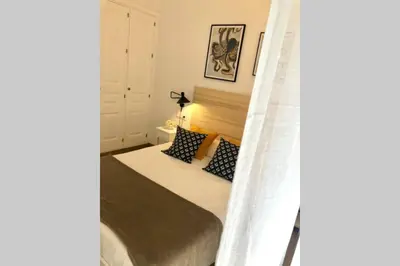 a bedroom with a bed and a bed frame at GATU PREMIUM Villa Libertad in Cádiz