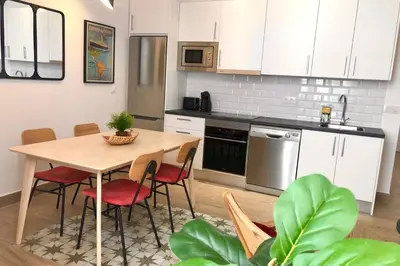 a kitchen with a table and chairs in a kitchen at GATU PREMIUM Villa Libertad in Cádiz