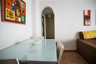 a living room with a glass table and a couch at Cerquita de la Caleta by Gades Gestión in Cádiz