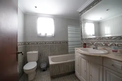a bathroom with a toilet and a sink and a tub at Cerquita de la Caleta by Gades Gestión in Cádiz
