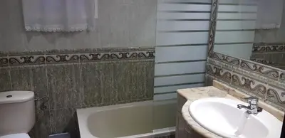 a bathroom with a sink and a toilet and a tub at Cerquita de la Caleta by Gades Gestión in Cádiz